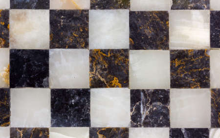 Close-up on a black e golden empty marble chessboardの写真素材