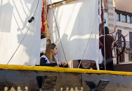 PADUA, Italy - February 21, 2016: A beautiful blonde girl on a carnival float shaped as a historic sailing ship during the february carnival paradeのeditorial素材