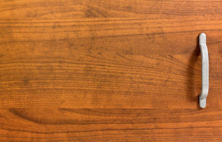 Closeup on the door of a classic wooden bedside cabinetの写真素材