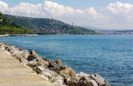 Skyline of Trieste, Italy, from the coastline in the Barcola districtの写真素材