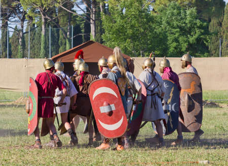 AQUILEIA, Italy - June 18, 2017 : Ancient Roman legionary soldiers during the final battle at the local annual historical reenactmentのeditorial素材