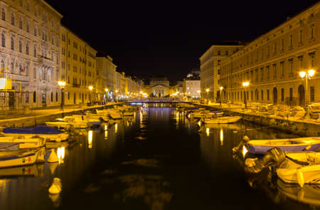 TRIESTE, Italy - August 3, 2017: Canal Grande and Piazza Sant'Antonio at night, with the neoclassic church of the same name in the backgroundのeditorial素材