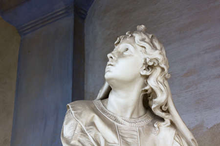 Marble statue of a woman looking upの写真素材