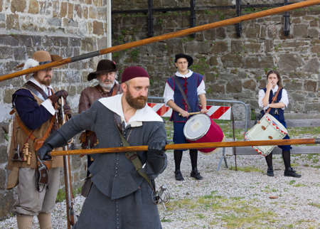 GORIZIA, Italy - May 6, 2018: Soldiers of the Seventeenth century Venetian army at the historical reenactment held at the castle, with a couple of drummers in the backgroundのeditorial素材