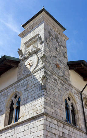 Corner tower of the historic town hall in Venzone, Italy