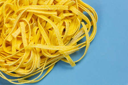 Italian egg pasta on a blue dishの写真素材