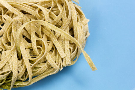 Italian spinach egg pasta on a blue dish