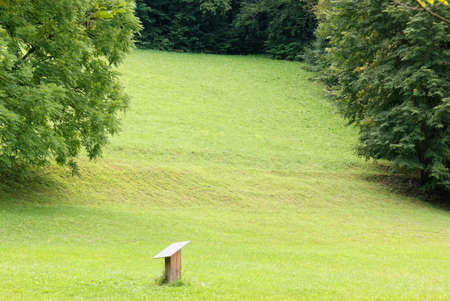 Educational sign in a meadow at the margins of a forestの写真素材