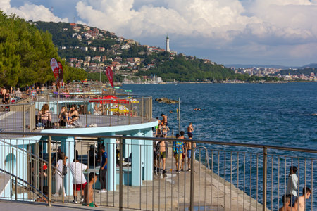 TRIESTE, Italy - June 6, 2020: The popular seafront in Barcola district crowded with young people just a few weeks after the covid-19 lockdownのeditorial素材