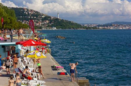 TRIESTE, Italy - June 6, 2020: The popular seafront in Barcola district crowded with young people just a few weeks after the covid-19 lockdownのeditorial素材