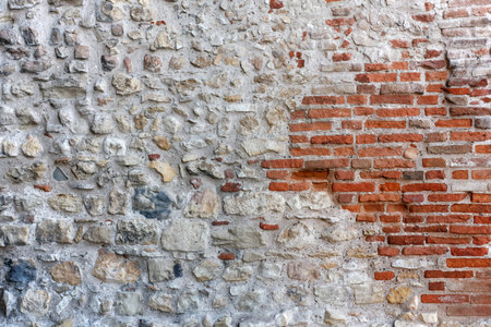 Ancient stone exterior wall with an inset of red bricks
