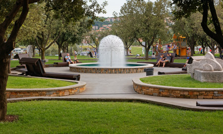 KOPER, Slovenia - July 21, 2014: Life in a city park, with a fountain at the centerのeditorial素材