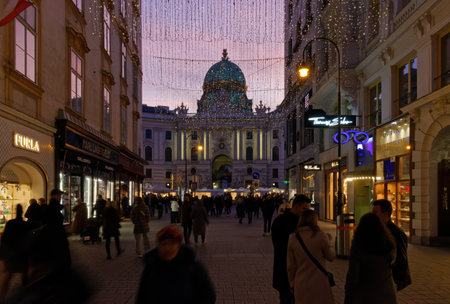 VIENNA, Austria - January 6, 2023: Kohlmarkt, pedestrian luxury shopping street just outside Hofburg palace, crowded with people in the eveningのeditorial素材
