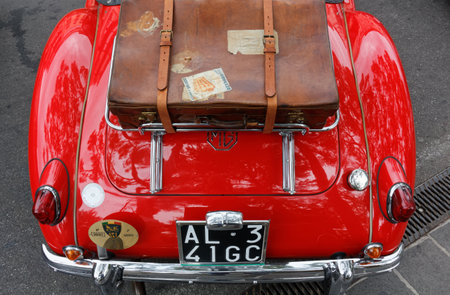 DESENZANO DEL GARDA, Italy - August 27, 2023: Close-up of the rear side of a red vintage car, seen from aboveのeditorial素材