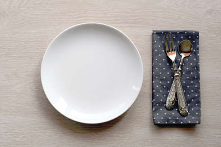 shabby chic table setting with wooden background and vintage cutlery. top viewの写真素材