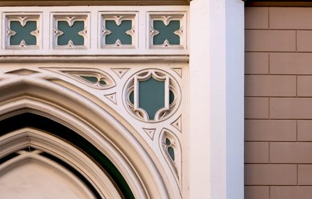 Detail of the facade of an old building with arched windows