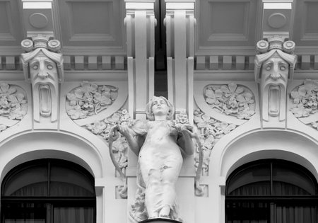 Statue of a woman on the facade of the building. Black and white.の写真素材