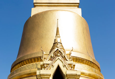 golden buddha statue in thailand temple and blue skyの写真素材
