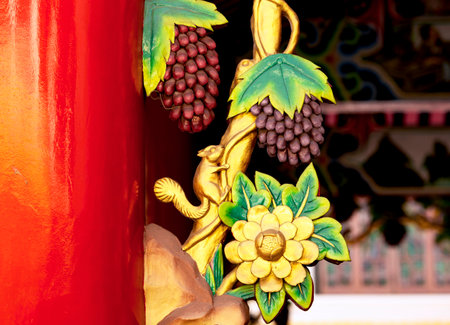 Grapes on the red door of the temple, Thailand.の写真素材