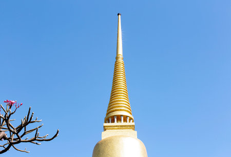 Golden pagoda on blue sky backgroundの写真素材