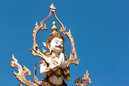 Giant statue in thai temple on blue sky background, Thailand.の写真素材