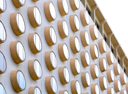 Close up of a modern office building with round wooden windows in a row