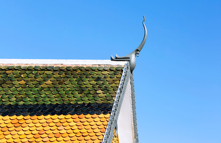 Thai temple roof with blue sky background, Wat Pho, Bangkok, Thailand