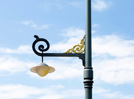 Lamp post with blue sky and white clouds in the background.の写真素材