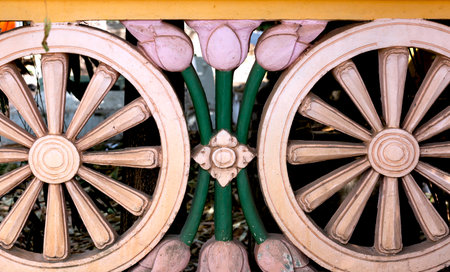 Close up of a wooden wheel of a wagon in a garden.の写真素材