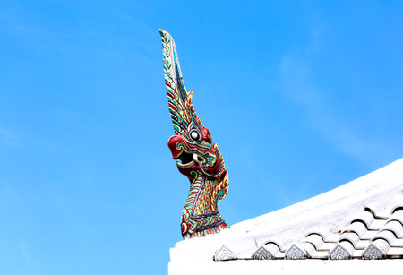 Giant statue on roof with blue sky background, Thailand.の写真素材