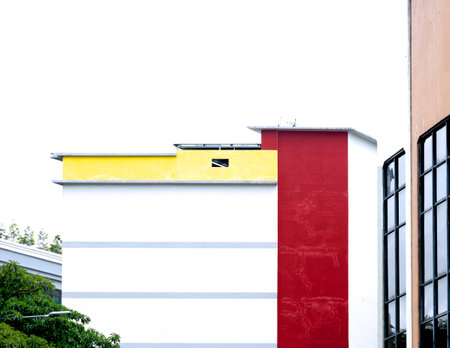 Red and yellow modern building with white wall and windows, Thailand.の写真素材
