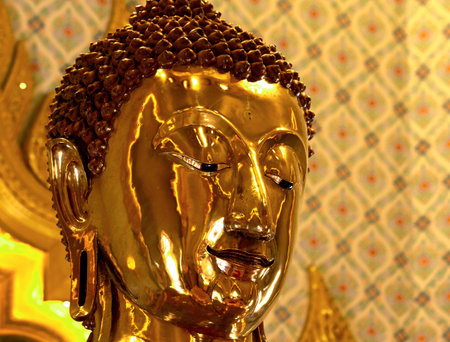 golden buddha statue in wat pho, bangkok, thailandの写真素材