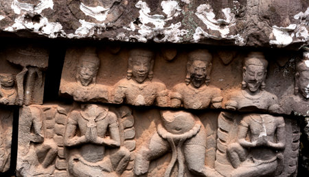 Ancient stone carving on the wall in a templeの写真素材