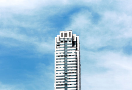 High rise building with blue sky and white cloud in Bangkok, Thailandの写真素材