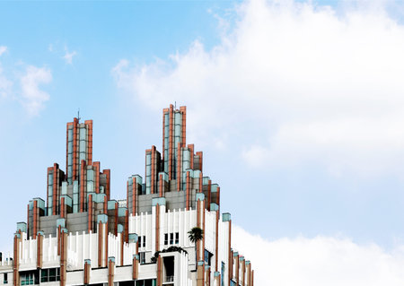 Facade of modern building with blue sky and white clouds as background