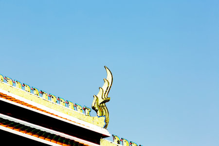 Thai temple roof with blue sky background.の写真素材