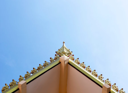 Thai temple roof with clear blue sky background.