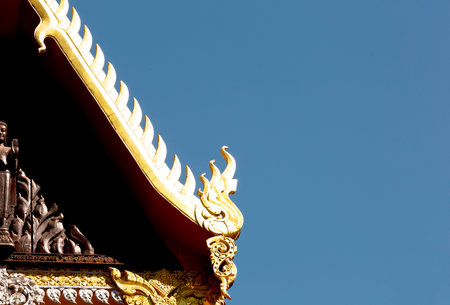 Thai temple roof with blue sky background, Thailand. (Selective focus)の写真素材