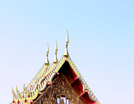 thai temple roof in the blue sky, thailand, closeup of photoの写真素材