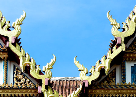 Thai style temple roof with blue sky background,Thailand.の写真素材