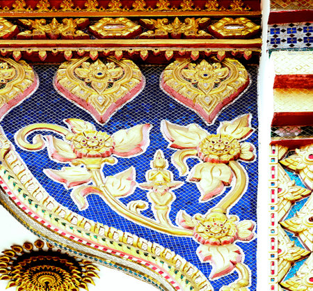 Thai style molding art on the wall of temple, Thailand.の写真素材