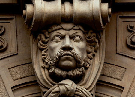 The face of a man with a mustache on the facade of the building