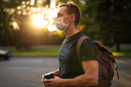 Man with backpack in the park in profileの写真素材