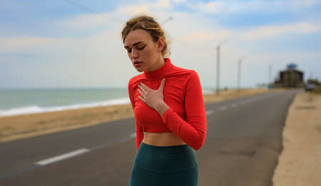 The girl is out of breath from running. on the roadの写真素材