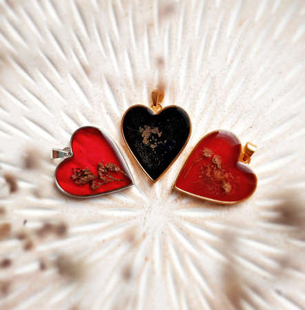 Heart shaped red and black gold pendant jewelry, dried flowers, golden necklacesの写真素材