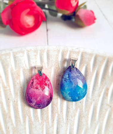 Silver handmade pendant, pink and blue color clouds, drop shaped jewelry, epoxy resinの写真素材