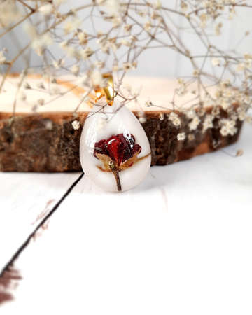 White handmade gold necklace, pendant with natural rose, epoxy resinの写真素材