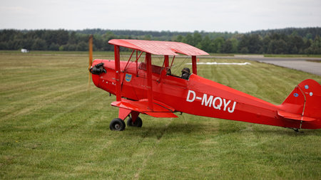 Red single engine biplane in the airfieldの写真素材