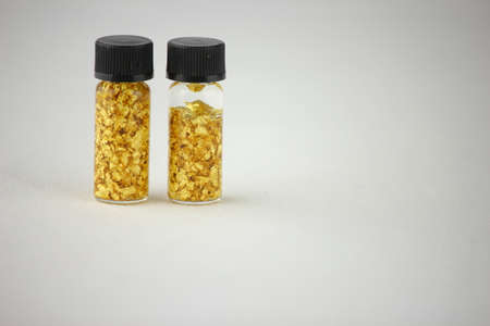 gold pieces in glass containerの写真素材