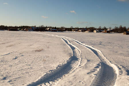 Tractor Tracks in Winter Fieldの写真素材